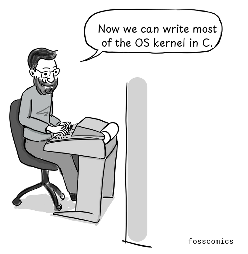 Ritchie smiles as he codes at a terminal.