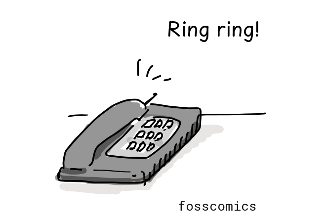 A telephone rings on the desk.