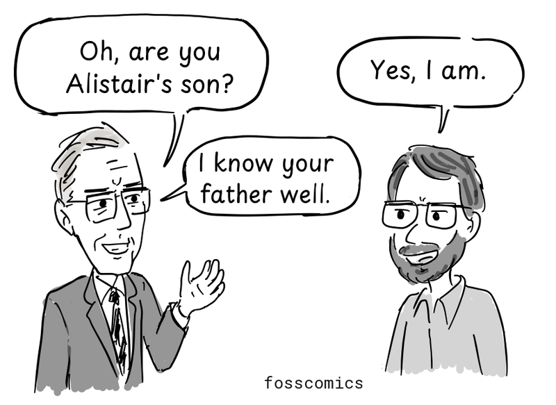 An older researcher welcomes the new arrival.
