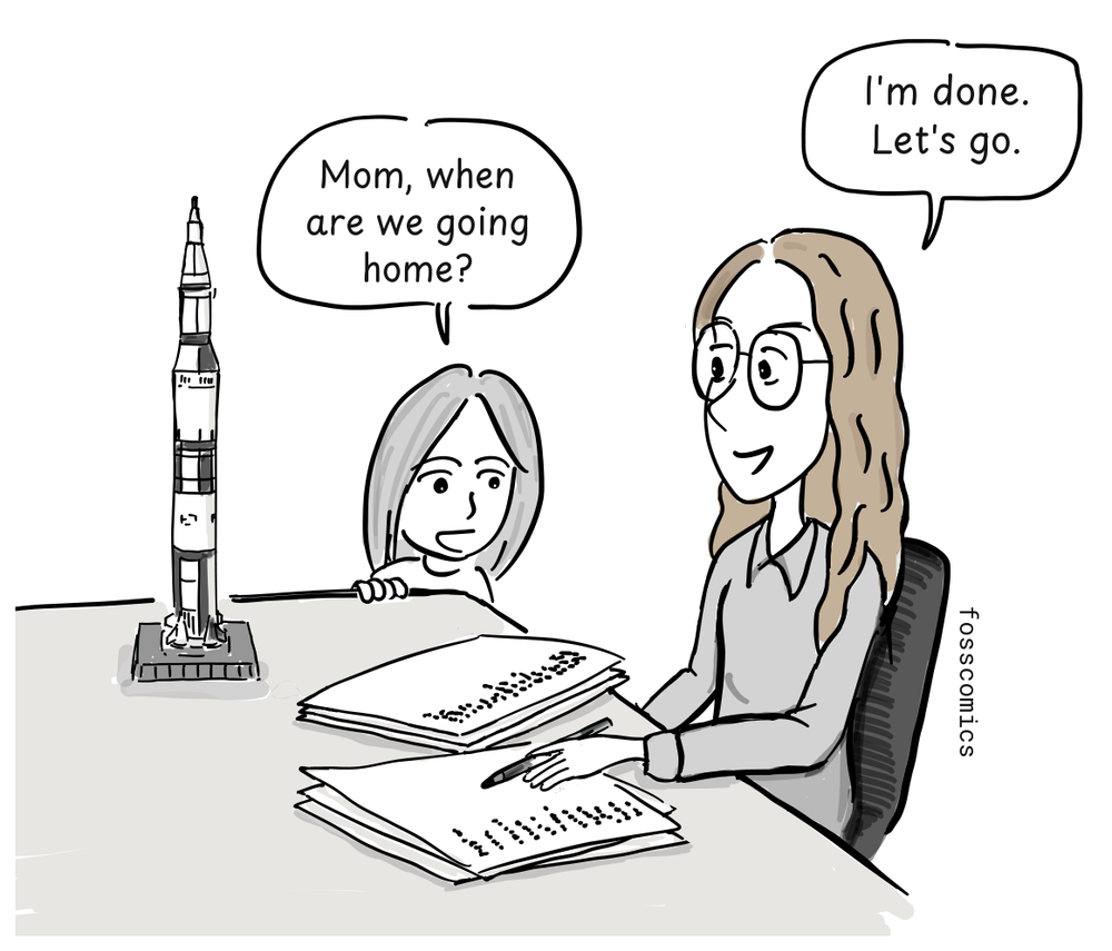 Margaret Hamilton works at a desk while her daughter waits beside a model of the Saturn V rocket.