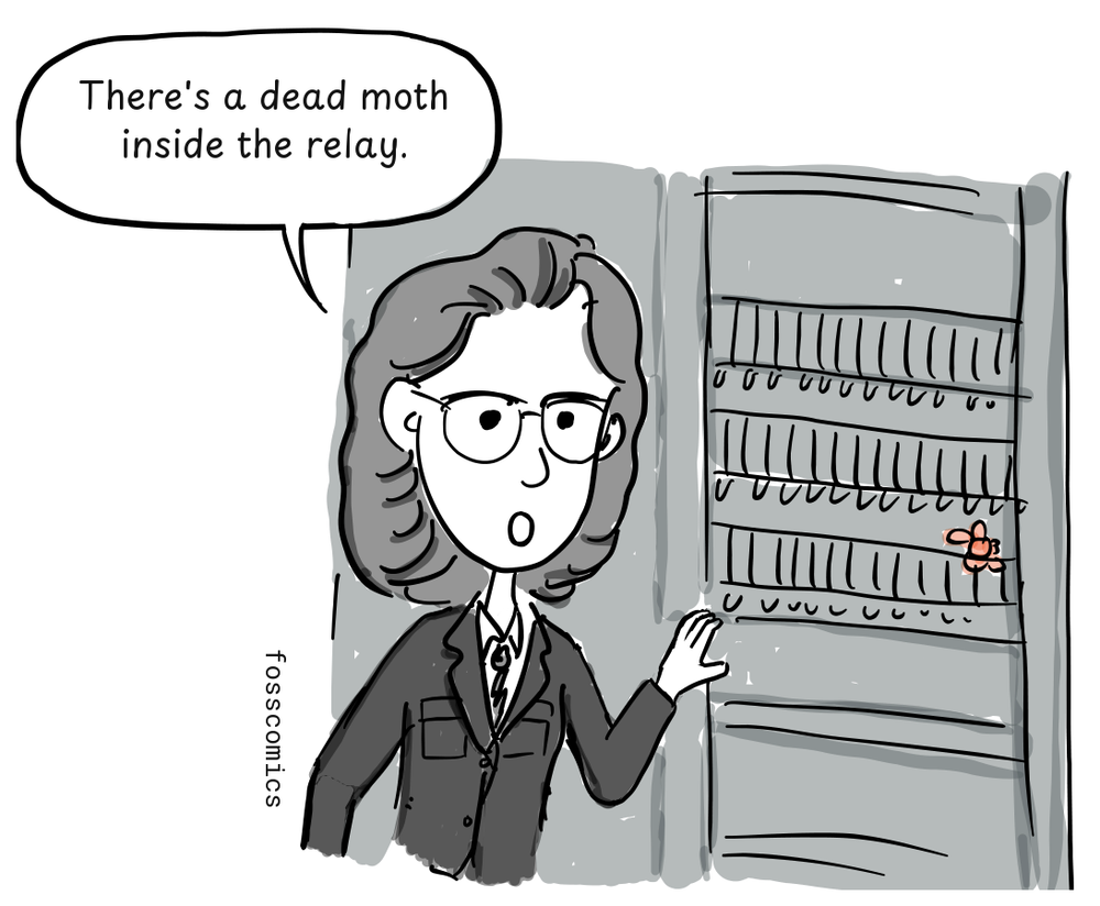 Grace Hopper points toward a moth caught among the Harvard Mark II's relays.