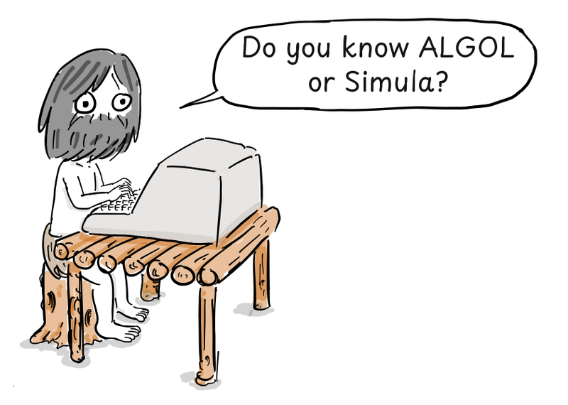 A bearded programmer works at a computer set on a rough log table.