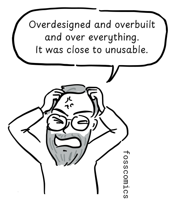 A frustrated programmer grips his hair while criticizing the complexity of Multics.
