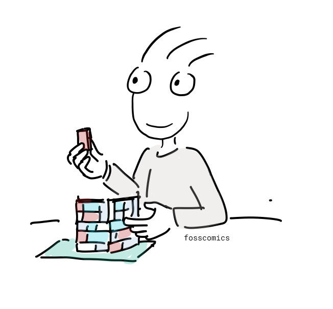 The presenter connects colorful toy bricks into a larger structure.